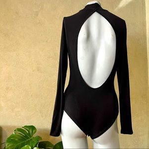 Black long sleeve body suit with open back and a loose low turtle; NWOT; Size S